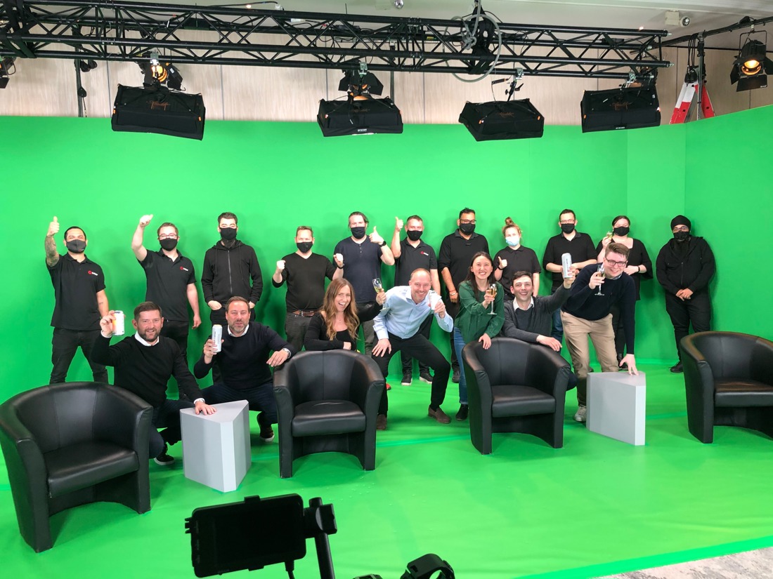 team in front of green screen